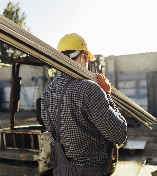 worker-with-hard-hat-carrying-wood